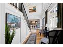 Welcoming foyer with staircase, wood floors, high ceilings, elegant decor, and views of dining room at 1012 Casa Dega Way, Raleigh, NC 27613