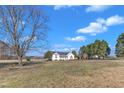 Wide angle shot of a single story home surrounded by a large grassy lawn at 103 Fieldstone Dr, Clayton, NC 27520
