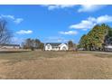 Wide shot of the front of a single story home surrounded by a large grassy lawn at 103 Fieldstone Dr, Clayton, NC 27520