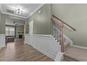 Inviting entryway with hardwood floors, elegant staircase, and views of the living area with fireplace at 106 Jared Ct, Graham, NC 27253