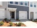 A townhome with a single-car garage, a neatly kept lawn, and a pleasant entryway at 112 Central Townes Way # 294, Raleigh, NC 27603