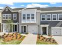 Charming townhomes with attached garages, professionally landscaped yards, and neutral color schemes at 116 Central Townes Way # 293, Raleigh, NC 27603