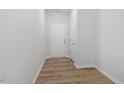 Bright hallway with white walls, light-colored floors, and a white door with chrome hardware at 116 Central Townes Way # 293, Raleigh, NC 27603