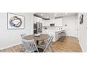 Modern kitchen with white cabinetry, stainless steel appliances, and a breakfast bar at 1257 S Blount Street # 101, Raleigh, NC 27601