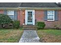 Inviting front entrance with a brick walkway, painted door, and classic architectural details at 127 Wilkinson St, Rocky Mount, NC 27804