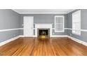 Spacious living room with hardwood floors, fireplace, white molding, and abundant natural light at 127 Wilkinson St, Rocky Mount, NC 27804