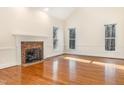 Bright living room features hardwood floors, fireplace, and large windows at 1532 Rockwood Downs Dr, Wendell, NC 27591