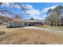 Ranch-style home with a single-car garage, long driveway, and spacious front yard with trees at 200 Barwick Way, Knightdale, NC 27545