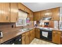 Traditional-style kitchen featuring wood cabinets, laminate countertops, and standard appliances at 200 Barwick Way, Knightdale, NC 27545