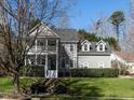Traditional two-story house with inviting front yard landscaping, showcasing classic architectural details and a welcoming facade at 2019 Falls River Ave, Raleigh, NC 27614