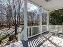 A relaxing porch view with a swing bed, showcasing the serene outdoor space and inviting ambiance at 2019 Falls River Ave, Raleigh, NC 27614