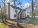 Side view of a well maintained home featuring a brick chimney, and gravel driveway at 2107 Spring Ln, Sanford, NC 27330