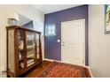 Stylish entryway with hardwood floors, a decorative cabinet, and neutral walls at 211 Monarda Way, Hillsborough, NC 27278