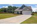 Beautiful home featuring a well-manicured lawn and a spacious two-car garage at 217 Walker Grv Ln, Lillington, NC 27546