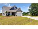 Lovely home showcasing a manicured lawn, a driveway, and a convenient two-car garage at 217 Walker Grv Ln, Lillington, NC 27546