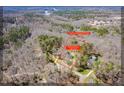 Stunning aerial view of a wooded property featuring a beautiful home and lush greenery at 2309 Laurelford Ln, Wake Forest, NC 27587