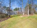 Lovely two-story home with a well-manicured lawn surrounded by mature trees at 2309 Laurelford Ln, Wake Forest, NC 27587