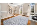 Inviting foyer featuring hardwood floors, staircase, and ample natural light from large windows at 2309 Laurelford Ln, Wake Forest, NC 27587
