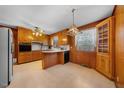 Spacious kitchen with wood cabinetry, breakfast bar, and classic appliances at 2311 Glover Rd, Durham, NC 27703