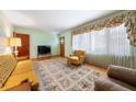 Cozy living room featuring a large window, patterned rug, and comfortable seating, creating a warm and inviting atmosphere at 2311 Glover Rd, Durham, NC 27703