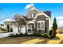 Charming home featuring a two-car garage, stone accents, and manicured landscaping at 2505 Mt Zion Church Rd Rd, Apex, NC 27502
