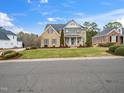 Inviting two-story home with brick facade, lush lawn, and beautifully landscaped front yard at 2639 Bowden Dr, Creedmoor, NC 27522