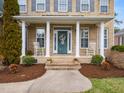 Charming front porch with rocking chairs, columns, and beautifully landscaped surroundings at 2639 Bowden Dr, Creedmoor, NC 27522