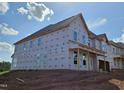 New construction home exterior featuring multiple windows and a covered porch at 3016 Dog Rose Dr # 303, Durham, NC 27703