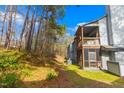 Backyard area with trees, lawn, screened porch, and outdoor seating at 32 Melstone Turn, Durham, NC 27707