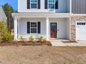 Welcoming front porch with classic columns, beautiful landscaping, and inviting entryway at 325 Azalea Gaze Dr, Youngsville, NC 27596