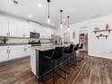 Stylish kitchen with white cabinets, granite countertops, stainless steel appliances, and pantry at 325 Azalea Gaze Dr, Youngsville, NC 27596
