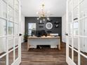 Home office with modern lighting, built-in shelves, and French doors at 325 Azalea Gaze Dr, Youngsville, NC 27596
