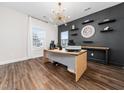 Home office featuring wood floors, a modern desk and stylish decor at 325 Azalea Gaze Dr, Youngsville, NC 27596
