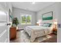 Bright bedroom with a large window, hardwood floors, and stylish decor at 3306 Leaflet Church Rd, Broadway, NC 27505