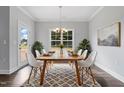 Elegant dining room with a wooden table, six chairs, and a chandelier at 3306 Leaflet Church Rd, Broadway, NC 27505