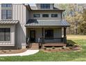 Charming front porch with black trim and a metal roof offers a welcoming entrance at 3601 Bivins Rd, Hillsborough, NC 27278