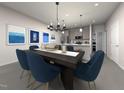 Open dining area with modern decor flowing into a kitchen, perfect for entertaining at 3717 Rosebush Dr, Zebulon, NC 27597