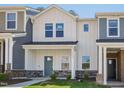 Charming two-story home with a modern farmhouse style, featuring a blue front door and stone accents at 3717 Rosebush Dr, Zebulon, NC 27597