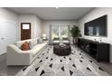 Bright living room with a comfortable sofa, geometric rug, and natural light from the large windows at 3719 Rosebush Dr, Zebulon, NC 27597