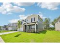 Lovely two-story home with a well-kept lawn, a two-car garage, and a cozy front porch at 3829 Rosebush Dr, Zebulon, NC 27597