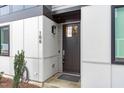 Close-up of the front door with modern hardware and stylish exterior lighting at 5 Seawell Ave # 106, Raleigh, NC 27601