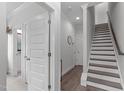 Bright hallway with staircase and multiple doors, providing access to different areas of the home at 5 Seawell Ave # 106, Raleigh, NC 27601