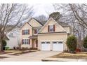 Charming two-story home featuring a two-car garage, red shutters, and a well-manicured lawn at 515 Littleport Dr, Rolesville, NC 27571
