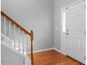 Bright foyer with hardwood floors, a staircase, and a front door with glass panels at 515 Littleport Dr, Rolesville, NC 27571