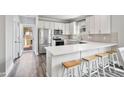 Bright kitchen with white cabinets, stainless steel appliances, and a breakfast bar with seating at 561 Circle Dr, Angier, NC 27501