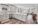 Modern kitchen with white cabinetry, stainless steel appliances, and hardwood floors at 561 Circle Dr, Angier, NC 27501