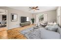 Bright living room featuring hardwood floors, large windows, and stylish decor at 5815 Windham Dr, Raleigh, NC 27609