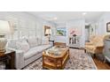 Bright living room featuring hardwood floors, natural light, and comfortable seating at 5920 North Hills Dr, Raleigh, NC 27609