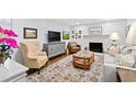 Cozy living room with fireplace, stylish decor, and hardwood floors at 5920 North Hills Dr, Raleigh, NC 27609