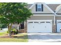 A two-story home with a two-car garage and a well-maintained lawn offers curb appeal and practicality at 63 Radcliffe Ct, Clayton, NC 27527